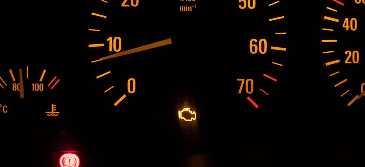 Auto technician using a tablet to analyze engine components during inspection